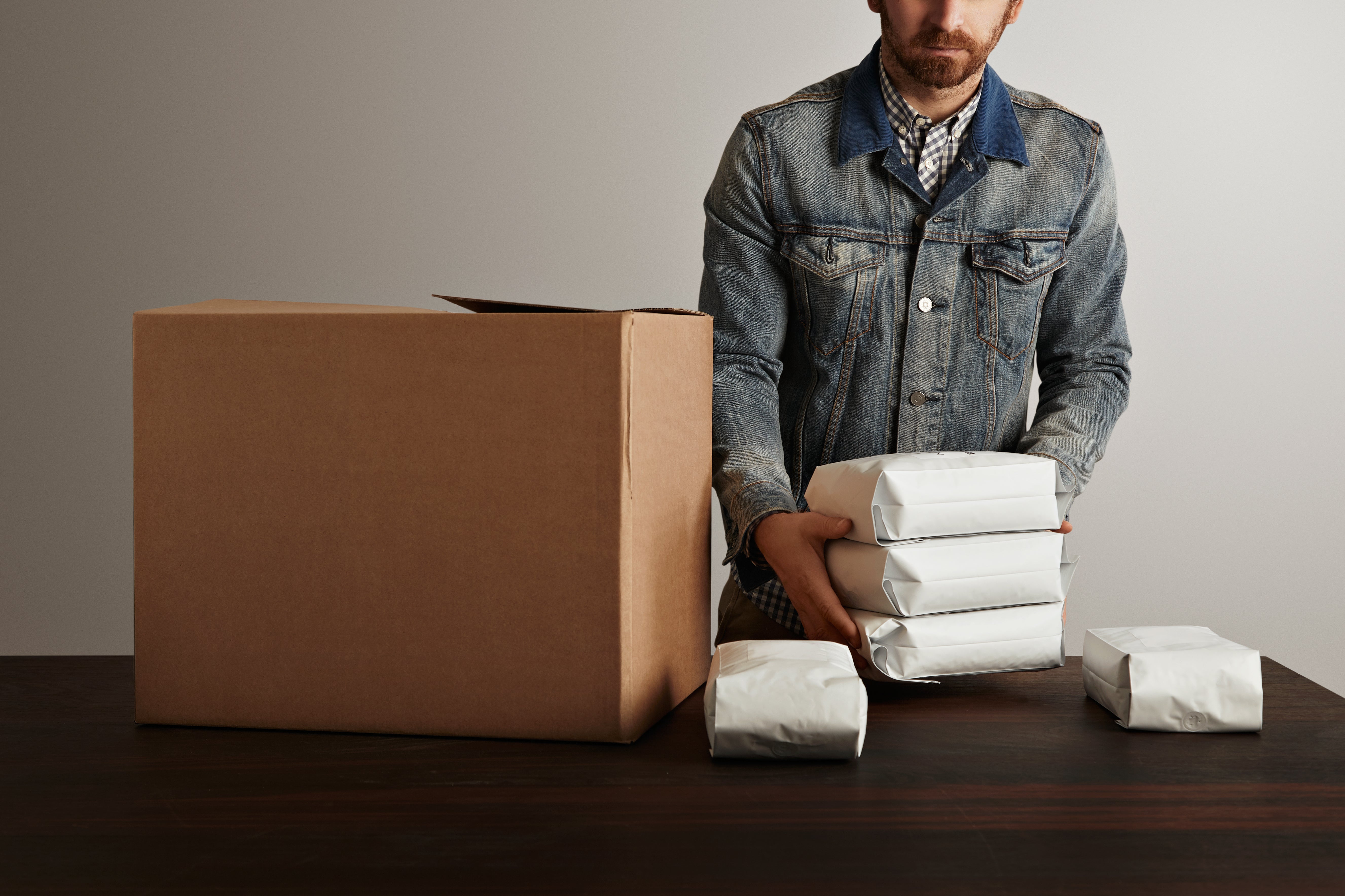 Man packing a box with protective materials