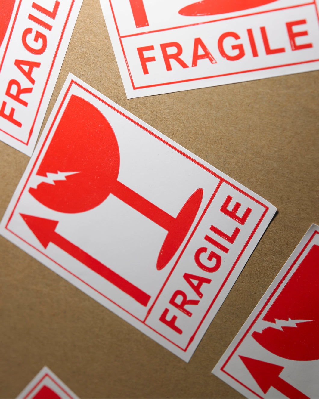Fragile labels with red symbols on a cardboard background