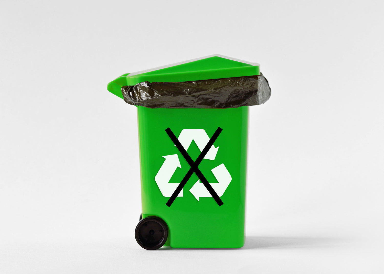 Green recycling bin with a black 'X' over the recycling symbol on a white background