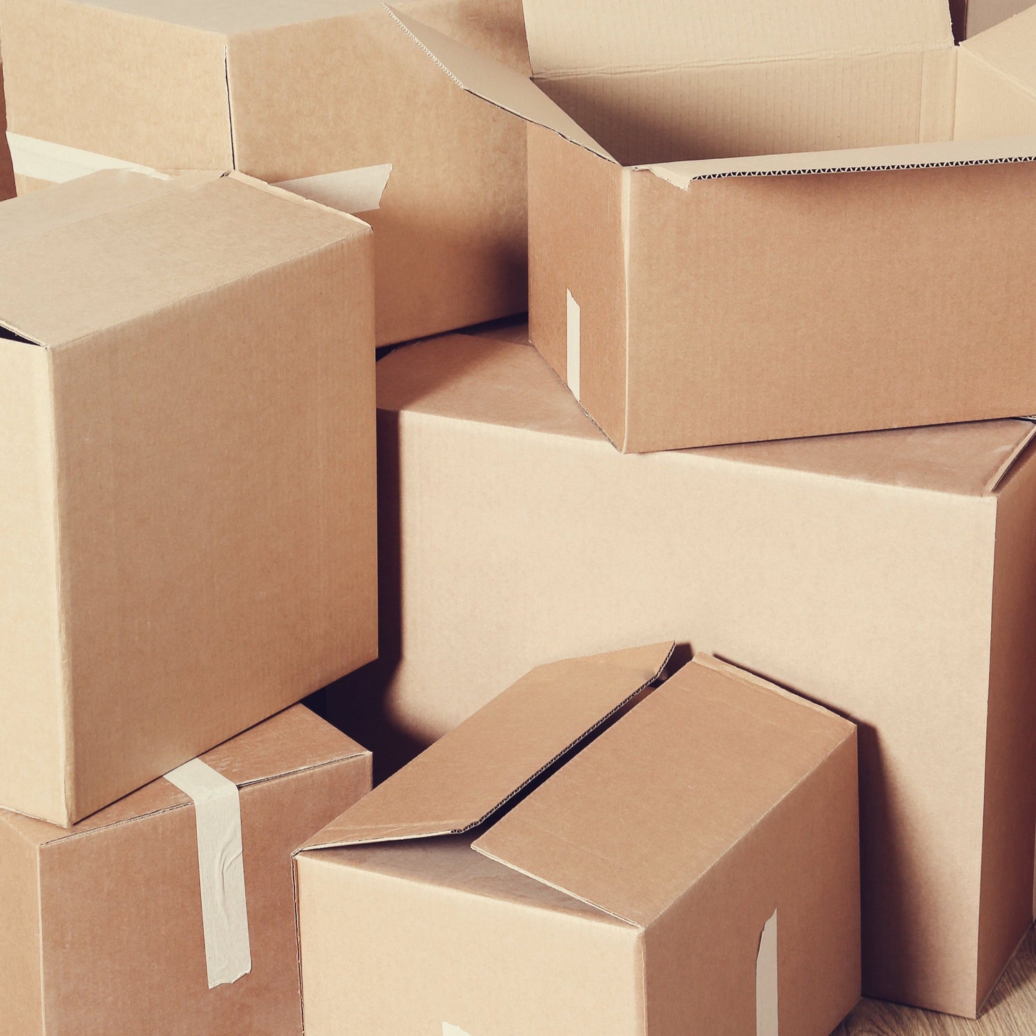 Stack of cardboard boxes on a wooden floor