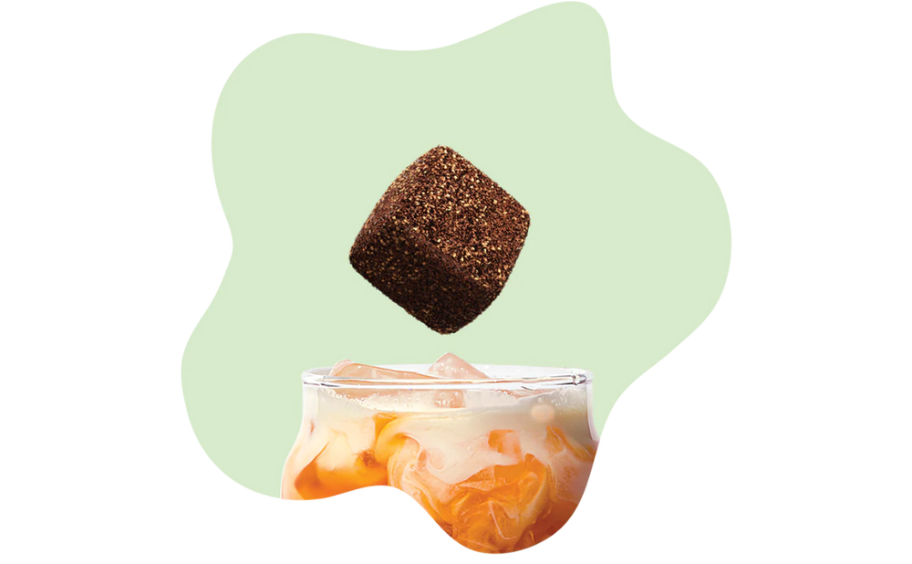 Individual Tea Drops tea cube product next to its home-compostable packaging pouch