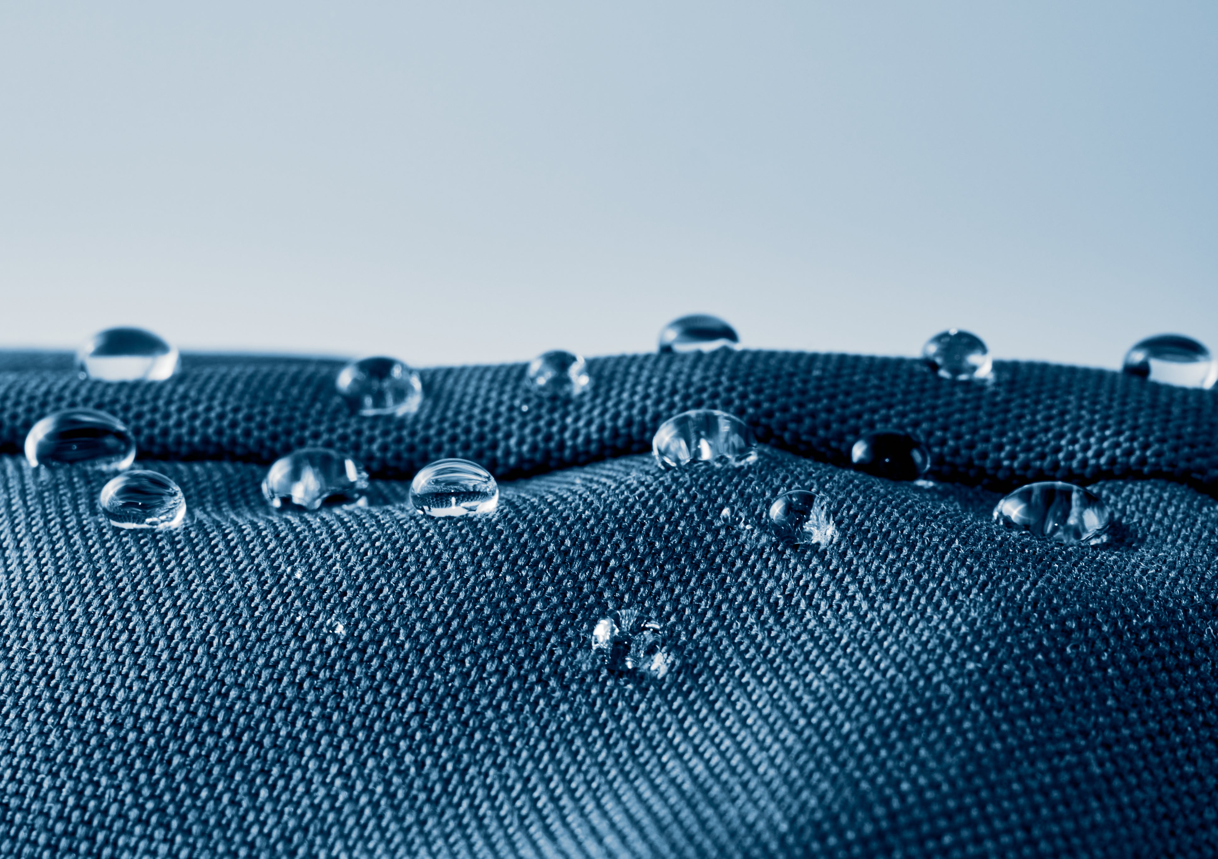 Water droplets on a textured blue surface